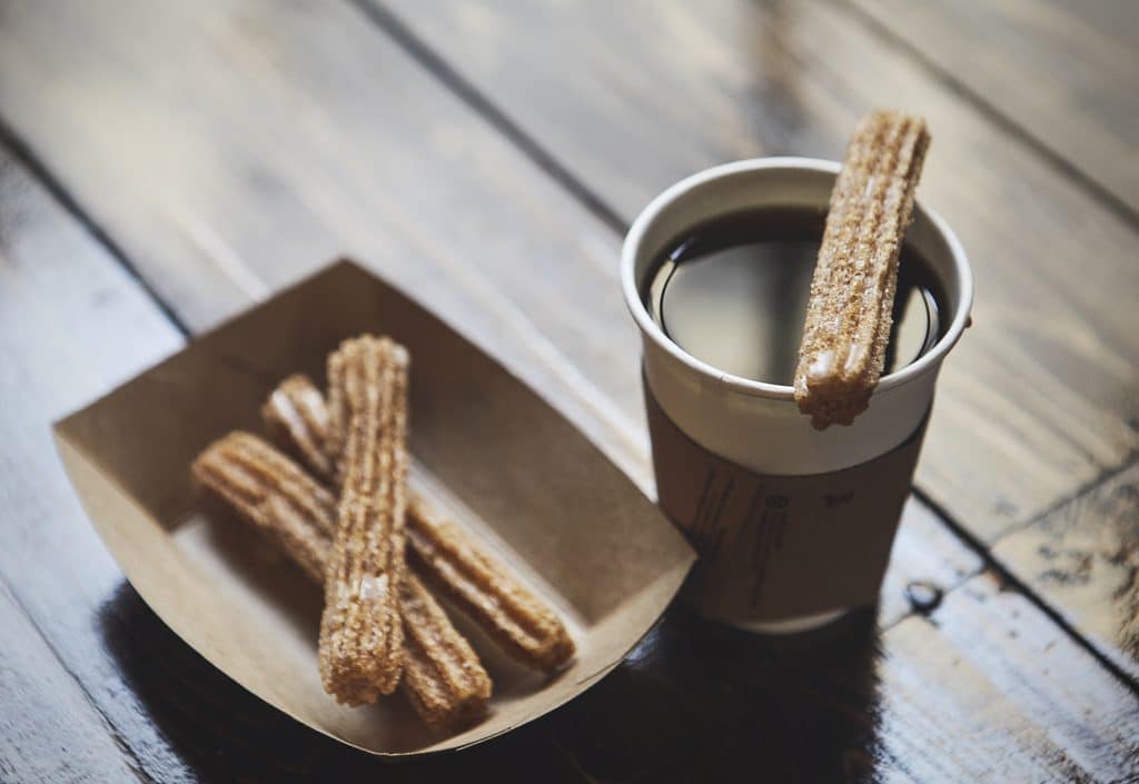 churros and coffee on a wooden table 2026 09 23 04 23 26 utc