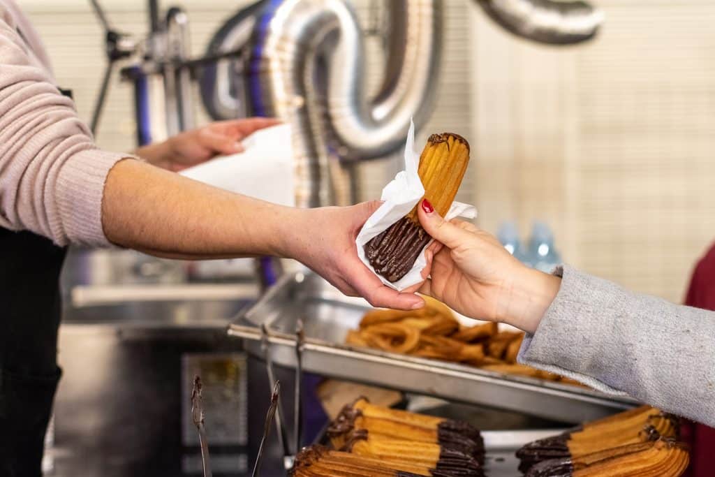 hands exchanging delicious churro dessert at marke 2026 09 24 05 13 18 utc 1