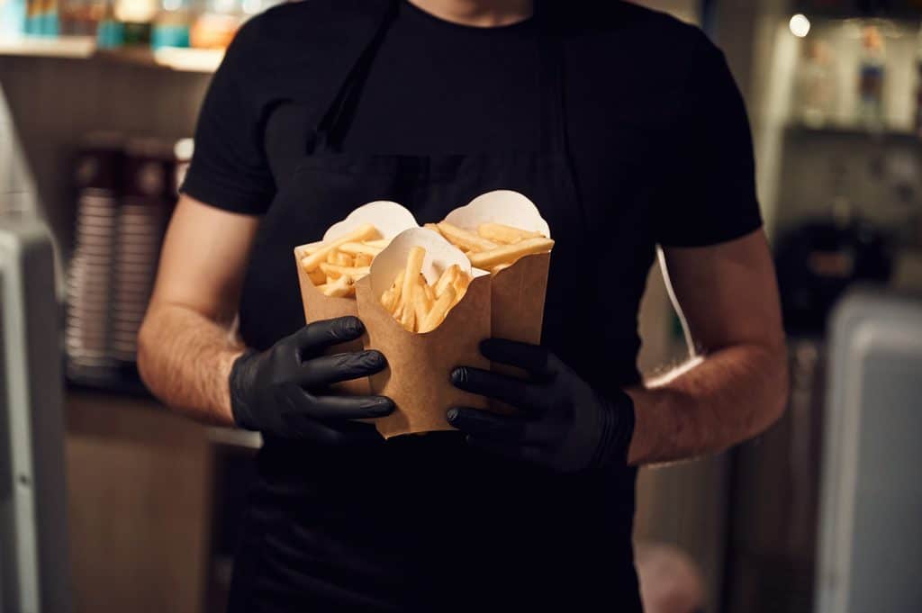 server carrying french fries in restaurant setting 2026 03 24 03 21 16 utc
