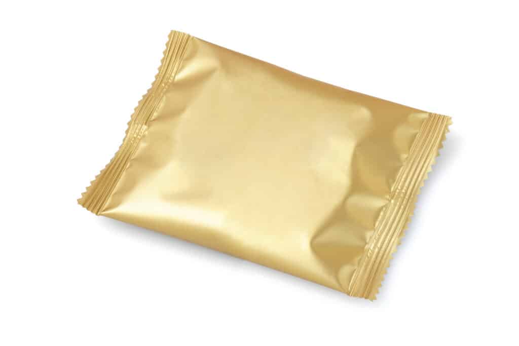 shiny golden foil wrapper on white background 2026 03 16 03 26 33 utc