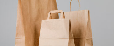 1brown paper bag with handles empty shopping bag with area your logo design food delivery concept